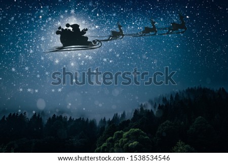 silhouette of a flying goth santa claus against the background of the night sky.