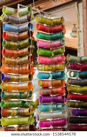 Colorful rows of Indian glass bangles hanging from the stand