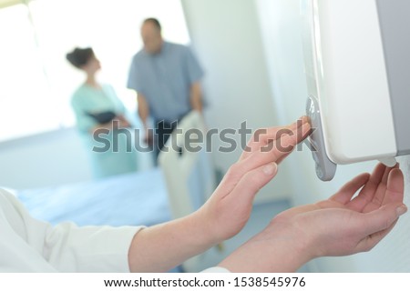 concept of an automatic dispenser hands Royalty-Free Stock Photo #1538545976