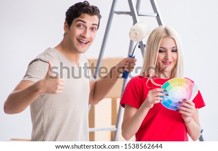 The young family doing painting job during home renovation