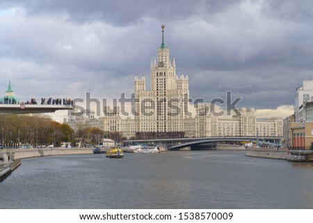 Photography of Stalinist skyscraper on Kotelnicheskaya embankment and Observation Deck Zaryadye Park, Bolshoy (Big) Ustinsky Bridge at autumn day. International touristic concepts.