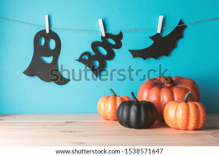 Holiday concept with Halloween pumpkin decor on wooden table. Creative Halloween minimal concept.