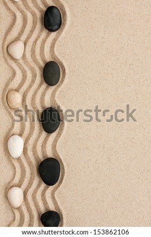 Black and white stones lie on the sand, can be used as background Royalty-Free Stock Photo #153862106