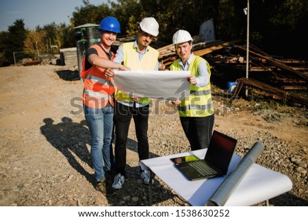Group of construction workers on building site.Stock photo