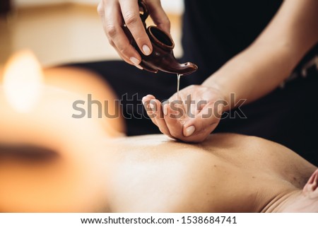 Aromatherapy massage is massage therapy using massage oil or lotion that contains essential oils  Royalty-Free Stock Photo #1538684741