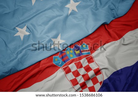 waving colorful flag of croatia and national flag of Federated States of Micronesia . macro