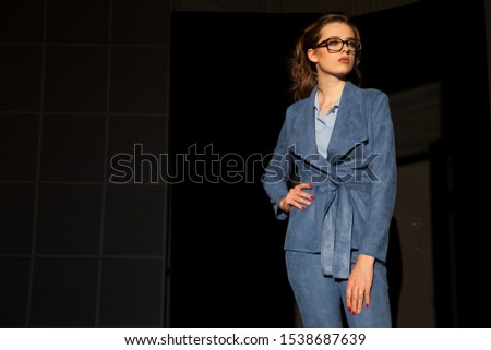 portrait of a beautiful fashionable woman in a business suit in the office