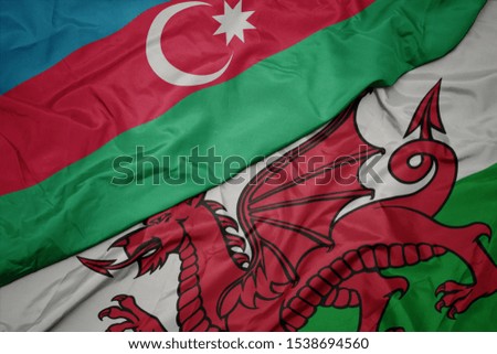 waving colorful flag of wales and national flag of azerbaijan. macro