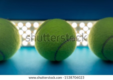 Photography of creative tennis balls, balls with a background of bright and rounded LED lights, natural and aesthetic shadow projections