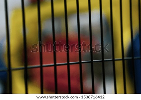 Wire mesh fence and a restricted area sign with colored background
