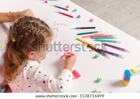 Woman child baby girl 4-5 years old draws are engaged in creativity. Mommy little kid daughter sit isolated on floor background studio portrait. Mother's Day love family parenthood childhood concept