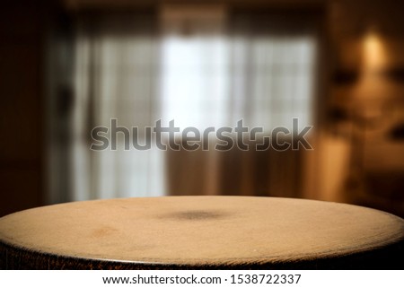 Wooden coffee table of free space for your decoration and blurred home interior. 