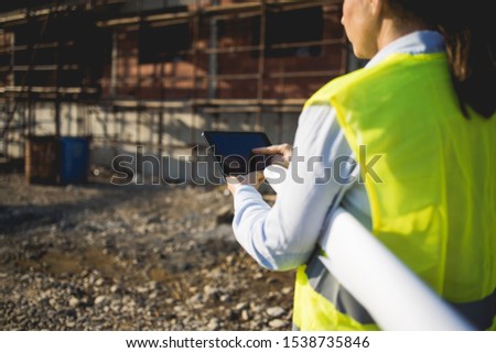 A woman construction worker on building site.Stock photo