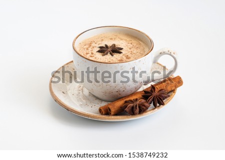 Indian Masala chai tea. Traditional Indian hot drink with milk and spices on white background close up. Royalty-Free Stock Photo #1538749232