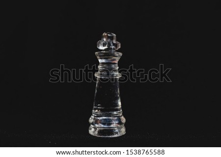 Piece of transparent chess,king,  black background