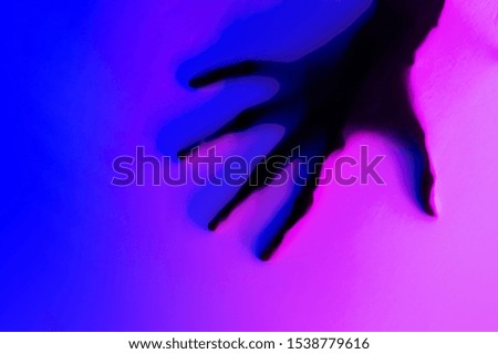 Hands in blue and pink neon light gradient behind white surface. Foggy blurred effect for different concept ideas. Trendy duotone illumination.