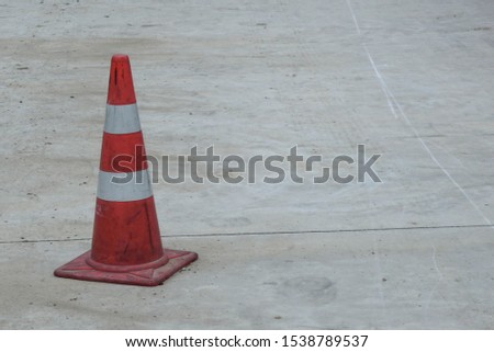 1 white and red traffic cone on the road