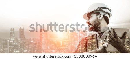 Double exposure image of construction worker with tablet computer and wearing construction uniform against the background of surreal construction site in the city. Royalty-Free Stock Photo #1538803964
