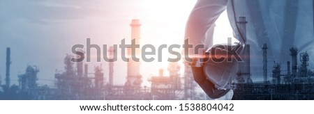 Future factory plant and energy industry concept in creative graphic design. Oil, gas and petrochemical refinery factory with double exposure arts showing next generation of power and energy business.