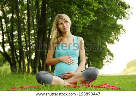 a beautiful young pregnant girl on nature