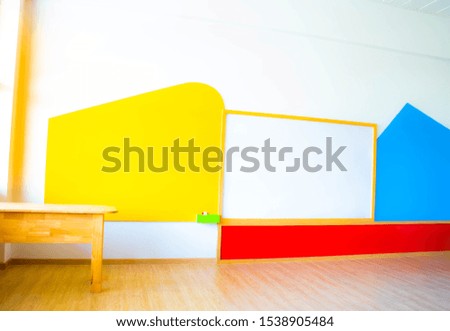 Beautiful kindergarten classroom that has colorful white board and table in the  class.
