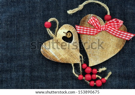 Couple of wooden hearts on jeans background