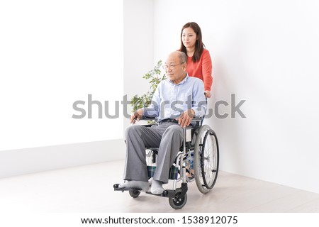 Women care for elderly person