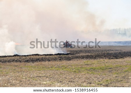 farmer burning straw on farmland