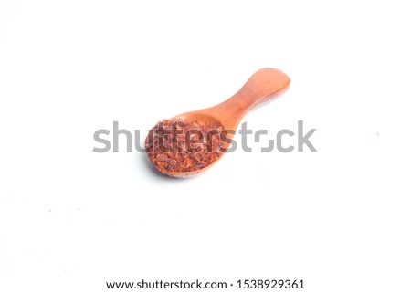 A picture of Turkish chilli flakes on mini spoon for marinated dish.