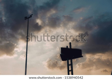 
The clouds in the sky are yellow and billboards
