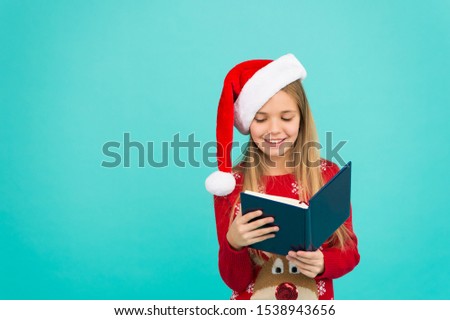 Christmas stories. Little reader copy space. Magic xmas spirit. Best Christmas book. Books store commercial. Little smiling child read book. Christmas eve. Little girl enjoy reading Christmas story.