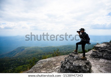 Male photographer traveling and photographing mountains