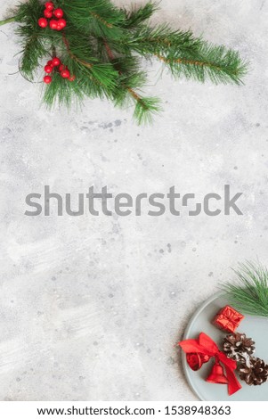 Christmas background. Fir tree brunch, cones and Christmas decoration on cement background. Winter holidays  and dinner concept. Copy space.