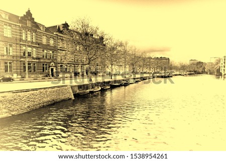 Urban scene in Amsterdam with typical local architecture. Embankment in the historical center of Amsterdam in the Netherlands. Vintage style toned picture