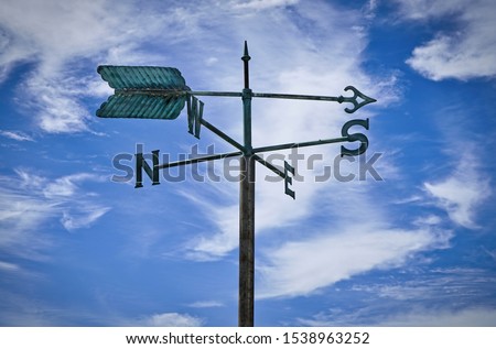 weather vanes with letters indicating the points of the compass Royalty-Free Stock Photo #1538963252