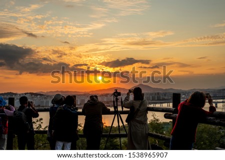 A people who takes pictures of the Hangang River park sunset. 