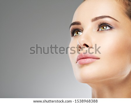 Beautiful face of young caucasian woman with perfect health fresh skin.  Skin care