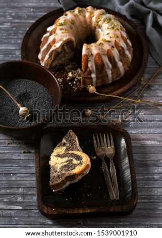 Decision poppy seed sponge marble cake slices in wooden plate. Rustic style. Sweet food concept. Selective focus. 