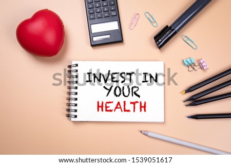 Invest In Your Health. Healthy lifestyle, recreation, insurance and family concept. Handwriitng text in the notebook