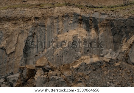 Nature background. Soft focus of geological landscape. Steep coastal cliffs. Cracked sand layer, rises filed with clay 