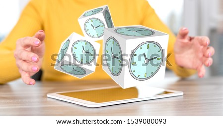 Digital tablet with time management concept between hands of a woman in background