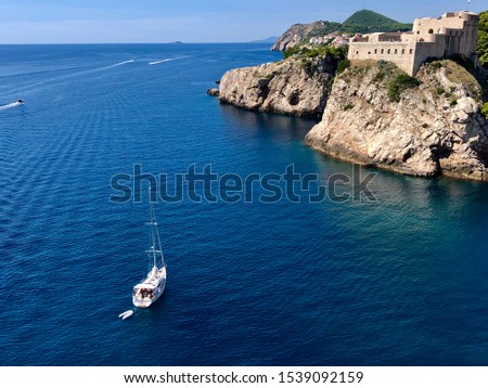 Ship (boat) swimming to the Croatian Dubrovnik castle at the island.