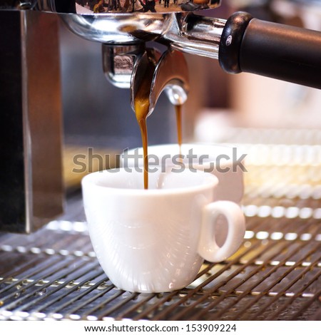 Prepares espresso in his coffee shop; close-up counter espresso automatic cappuccino bari sta portability coffee-shop coffee shop coffee mill coffee house coffee machine coffee dispenser Royalty-Free Stock Photo #153909224