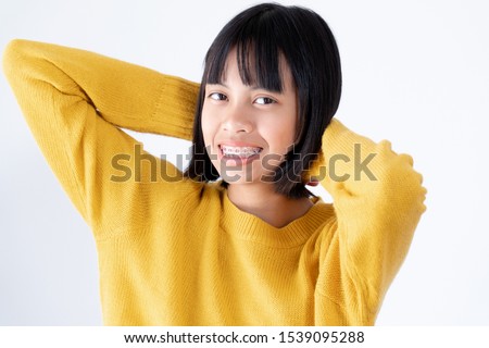 Portrait of Girl Wearing Yellow Swather with Attractive Black Eyes and Dental Brace Smiling and Happy on White Background