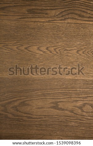 vertical filled frame close up background wallpaper shot of a wooden plank parquet floor forming beautiful patterns and shapes