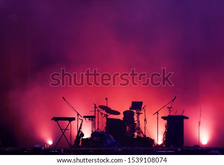 concert stage on rock festival, music instruments silhouettes, colorful background with copy space Royalty-Free Stock Photo #1539108074