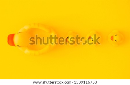 Yellow rubber duck isolated on a yellow background.