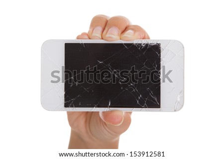 Hand holding smartphone with cracked screen over white background