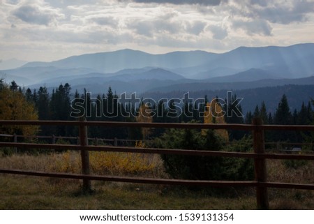 Fence in the countryside. Forest in the mountains.