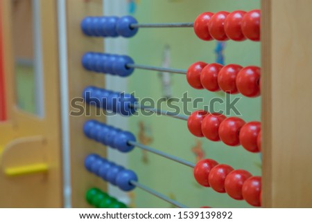Traditional abacus with colorful wooden beads on white background. Toy abacus to learn counting. Colorful children counting frame for kids. Top side view.abacus with red green blue and balls